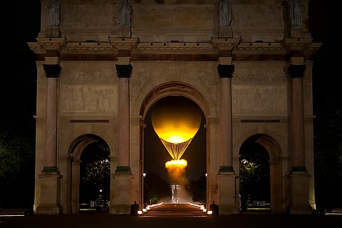 The cauldron rises by the Arc de Triomphe du Carrousel in Paris